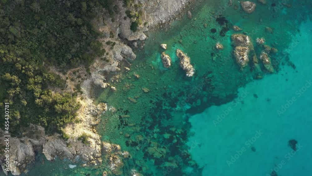 View from above, stunning aerial view of a green and rocky coastline bathed by a turquoise, crystal clear water. Sardinia, Italy. View from above, stunning aerial view of a green and rocky coastline bathed by a turquoise, crystal clear water. Sardinia, Italy.