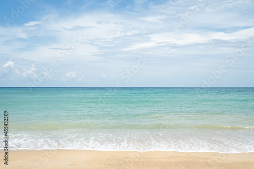 beach with sky and clouds.Landscape waves nature splashes beach sunlight.Blue sea waves and sky on sand beach.