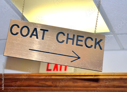 Coat check sign displayed indoors.
