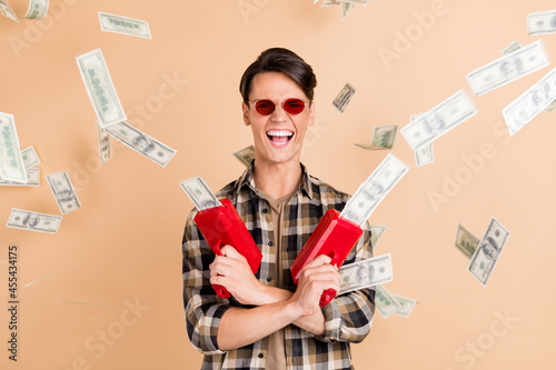 Konstfotografi Photo of positive rich guy hold gun throw cash usd wear sunglass plaid shirt iso