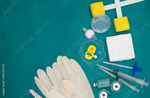 Epidural set isolated on green. Epidural anesthesia set, Sets for continuous epidural anesthesia. Epidural nerve block kit with epiduralcatheter and gauze, betadine solution isolated