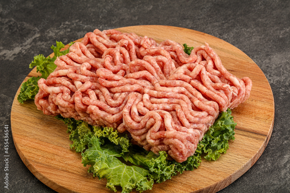Raw pork minced meat over board Raw pork minced meat over board