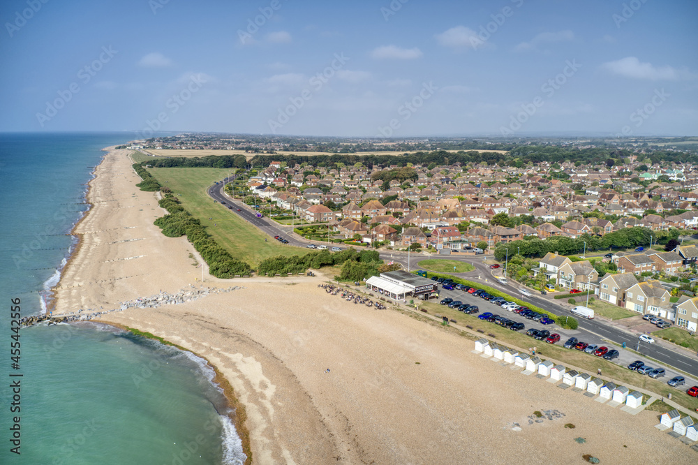 Goring by Sea beach with the popular Cafe with the greensward in view behind the beach at this popular family seaside resort. Aerial photo.