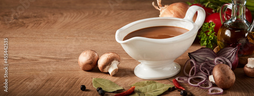 Sauce boat or sauciere filled with a rich brown gravy photo