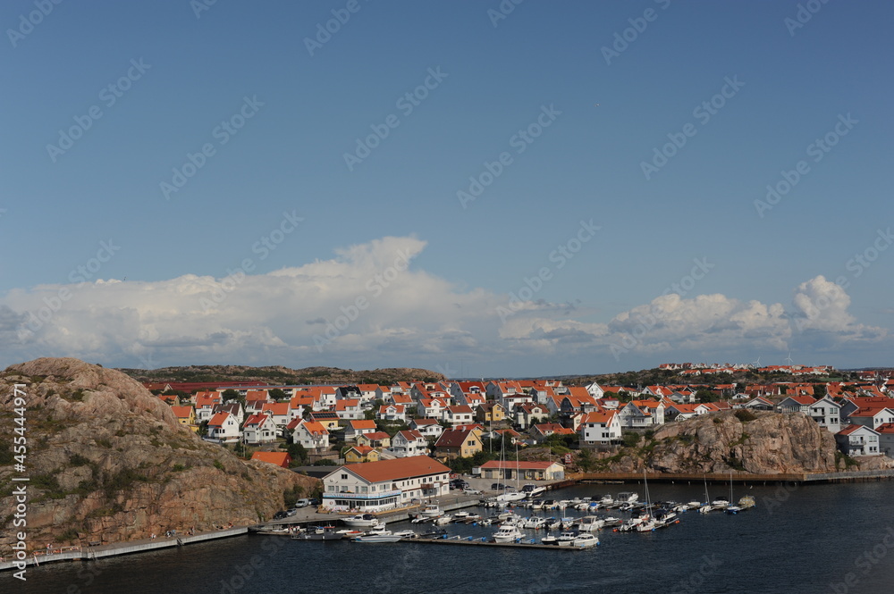 Scenic panorama of a waterfront with boats, yachts and houses in Kungshamn (Sotenäs, Västra Götaland, Sweden) on a sunny day in summer