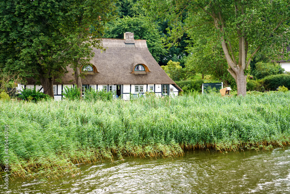 Beautiful Schlei region in Germany, Schleswig Holstein. German landscape in summer. Schlei river and typical houses with thatching, water reed roofs. Sieseby village Beautiful Schlei region in Germany, Schleswig Holstein. German landscape in summer. Schlei river and typical houses with thatching, water reed roofs. Sieseby village