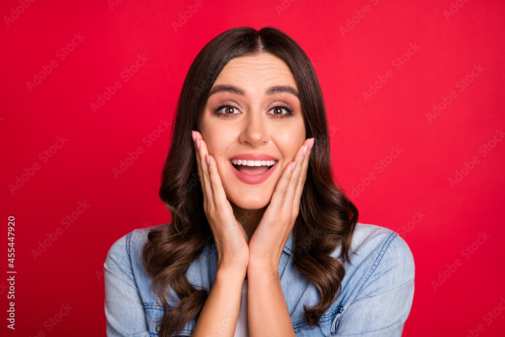 Portrait of attractive amazed cheerful gorgeous wavy-haired girl good news reaction isolated over bright red color background Portrait of attractive amazed cheerful gorgeous wavy-haired girl good news reaction isolated over bright red color background