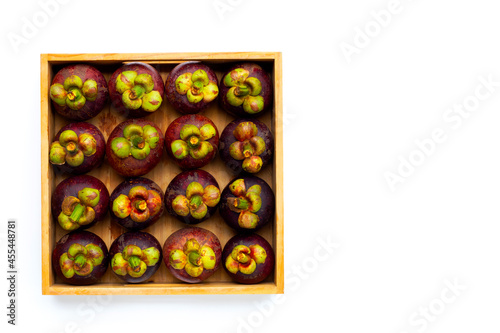 Mangosteen in wooden box on white background.