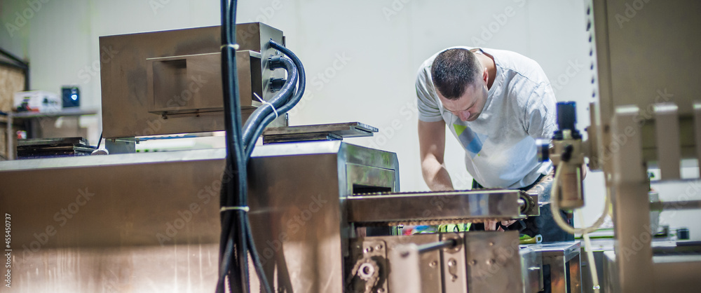 Professional worker technician machinist work in factory production workplace. Industrial working operating process