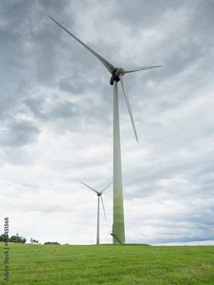 Meadow grass and windmill energy farm. Meadow grass and windmill energy farm.