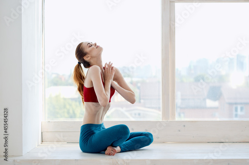 Free Download woman doing yoga exercises near the window energy asana - GFXLoad