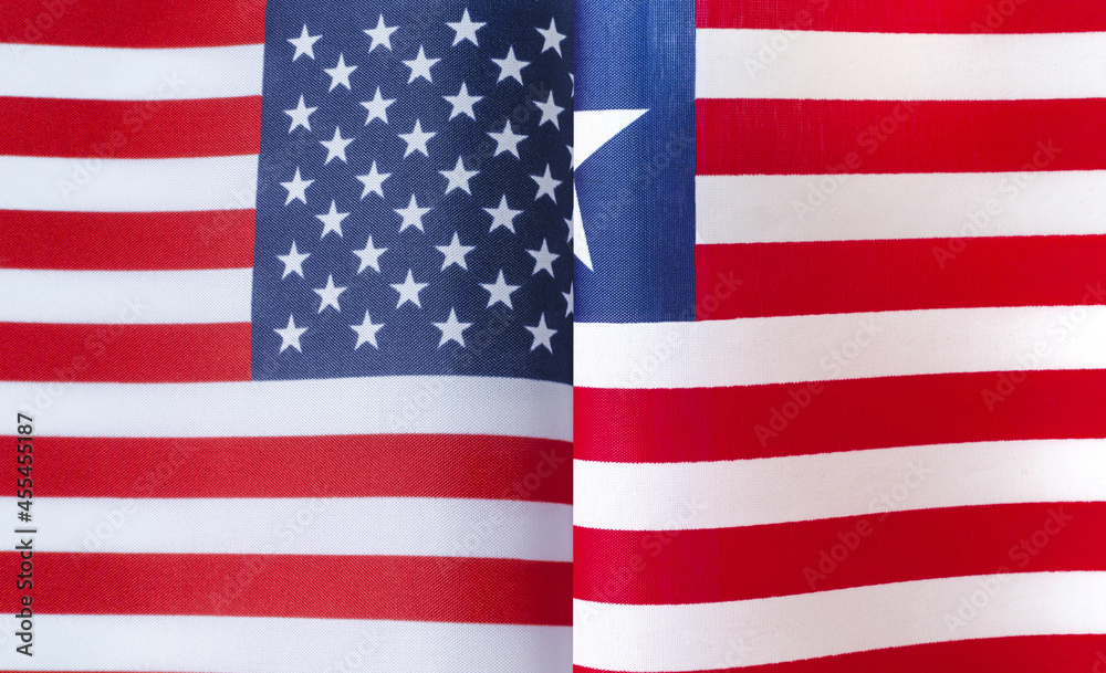 Fototapeta premium fragments of the national flags of the United States and the Republic of Liberia close-up