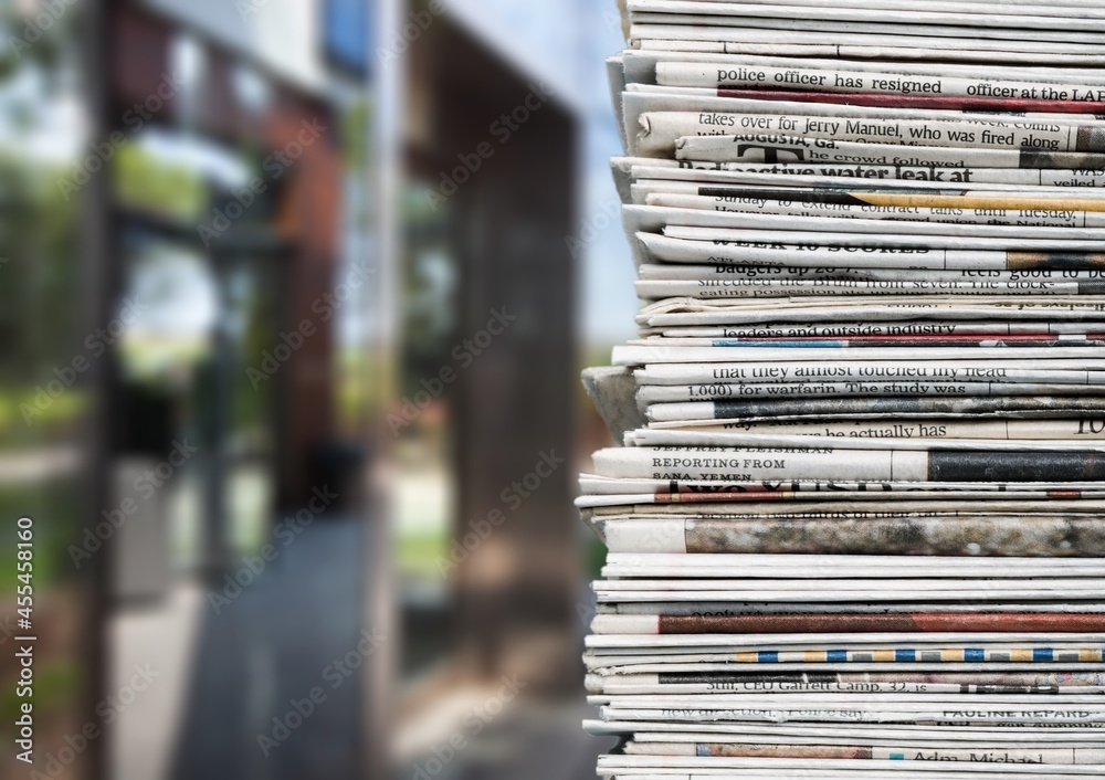 Pile of fresh newspapers on a blur background Pile of fresh newspapers on a blur background