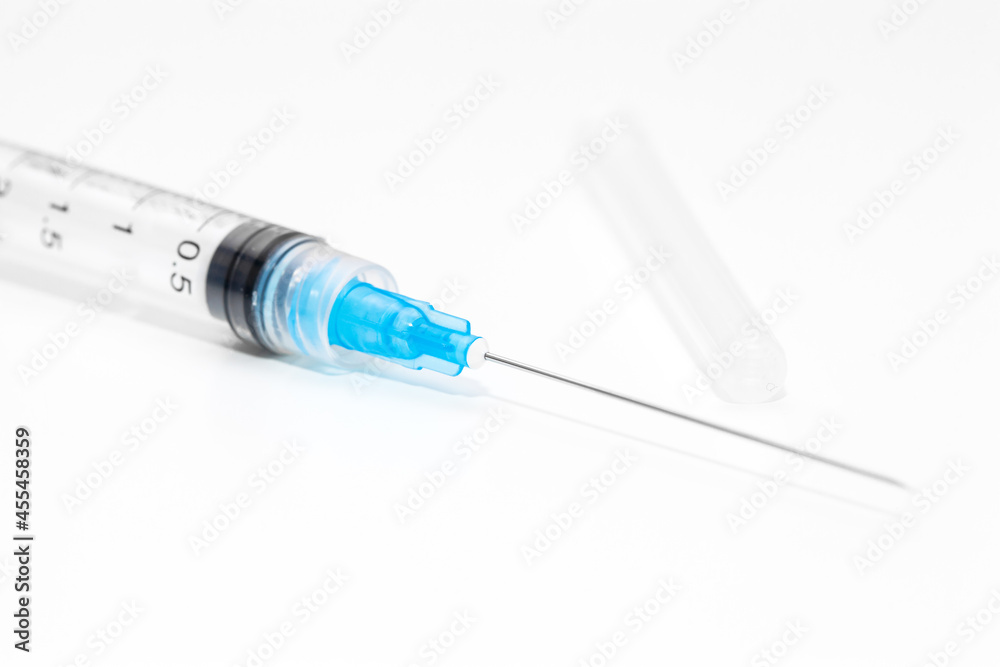 Disposable syringe medicine with needle on, selective focus Disposable syringe medicine with needle on, selective focus