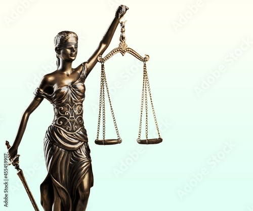 Themis Statue with Justice Scales on bright background.