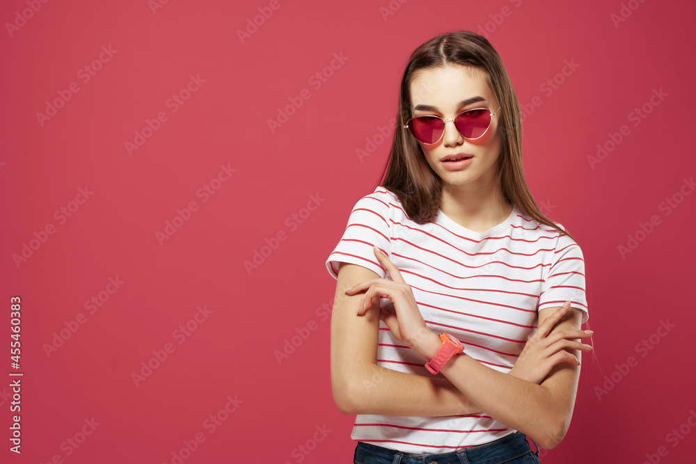 Fototapeta premium pretty woman wearing glasses striped tshirt styles posing pink background