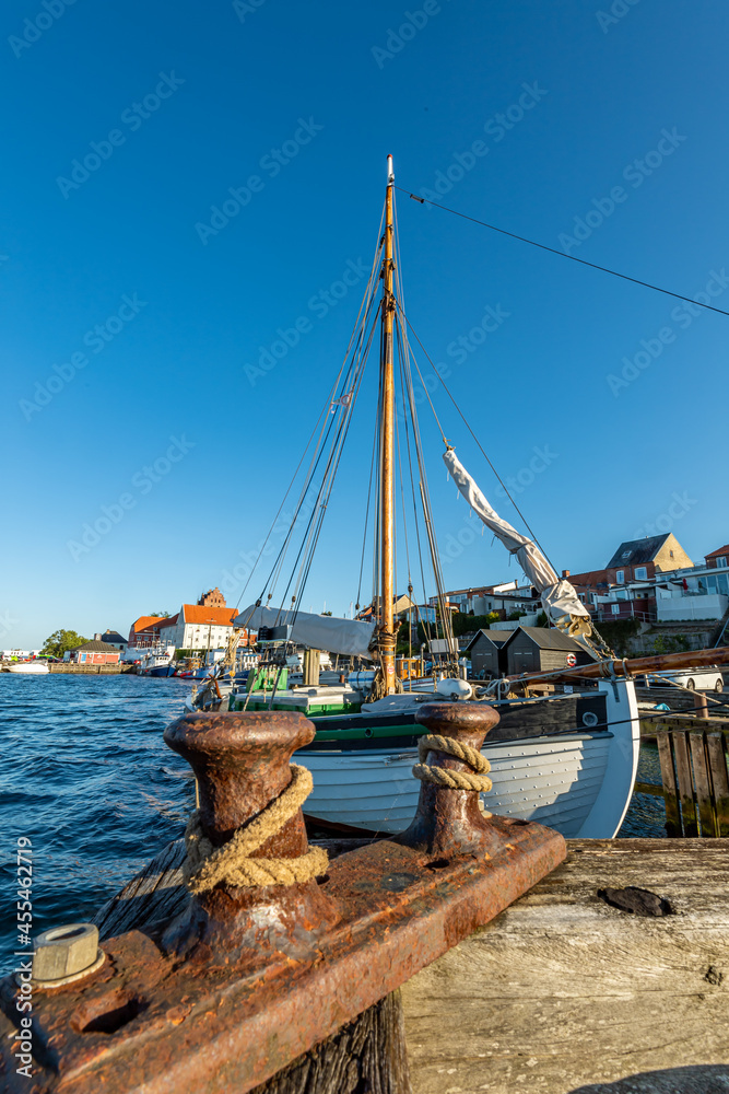 Denmark, Faaborg, 04-09-2021 overview picture of the harbor with ships in the background. Here wooden ship with pillars mast Denmark, Faaborg, 04-09-2021 overview picture of the harbor with ships in the background. Here wooden ship with pillars mast