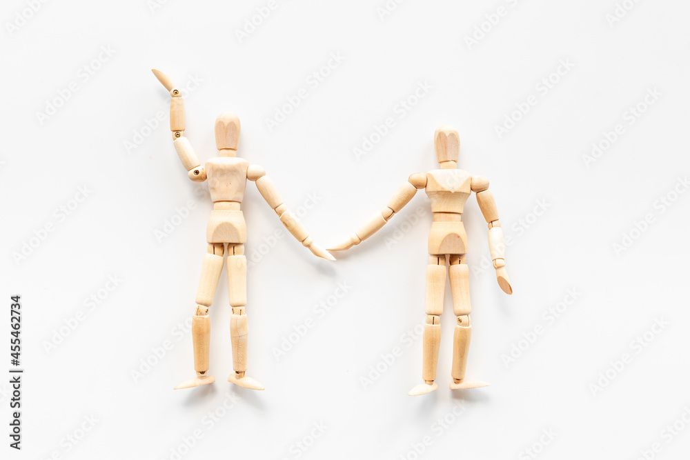 Couple of wooden figures - man and woman connection. Love and dating concept Couple of wooden figures - man and woman connection. Love and dating concept