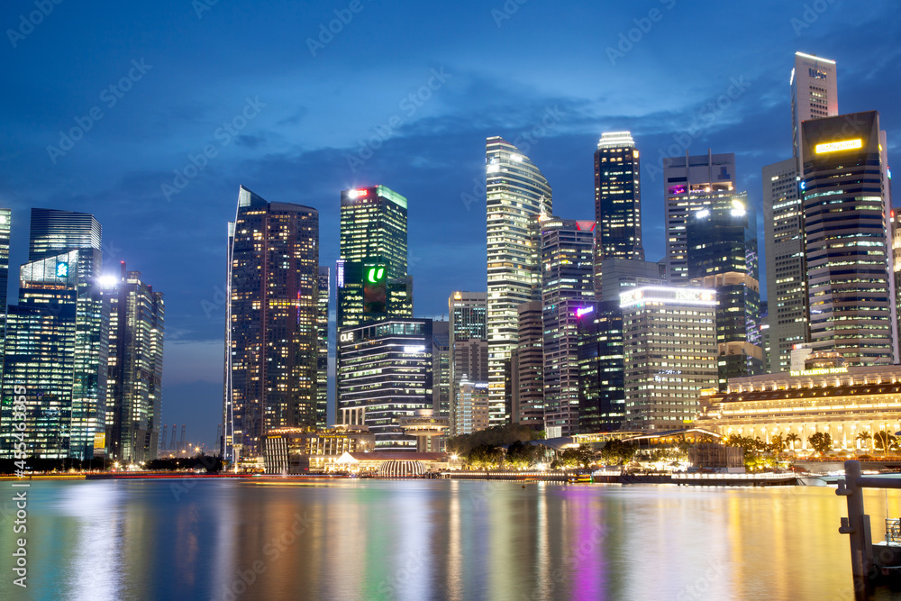 SINGAPORE, SINGAPORE - MARCH 2019: Skyline of Singapore Marina Bay at night with Marina Bay sands, Art Science museum , skyscrapers and tourist boats
