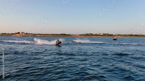 Spectacular close encounter between water scooters in the sea photo