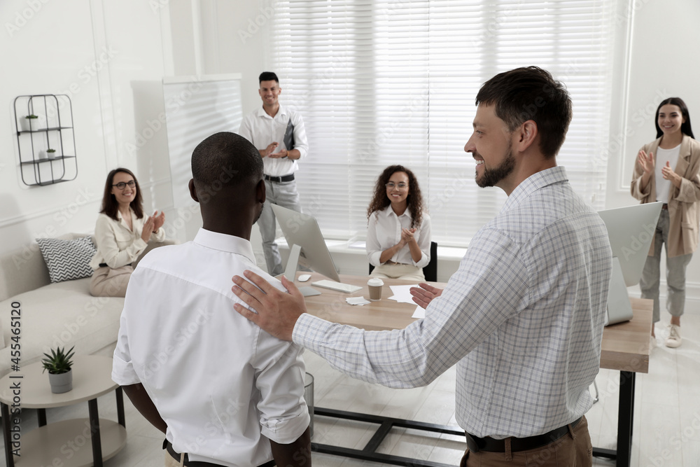 Boss introducing new employee to coworkers in office Boss introducing new employee to coworkers in office