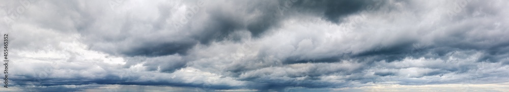 Stormy cloudy sky wide panorama, dramatic dark blue thunderclouds, gale cloudscape, gray cumulus rain clouds panoramic view, thunderstorm heaven landscape, overcast cloudiness weather, hurricane skies