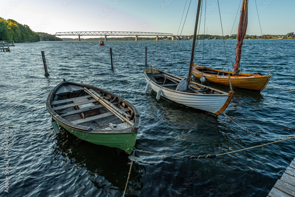 Naklejka premium Denmark, Middelfart, 04-09-2021- Old and new wooden dinghies, are moored