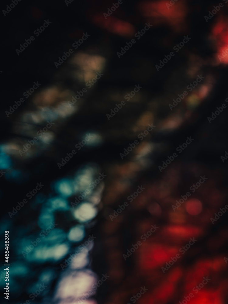 Fototapeta premium Abstract geometry of blue, red, and black shadows in the forest