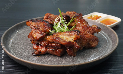 bbq grilled tender pork chop meat with sauce on dark grey wood background dim sum halal menu
