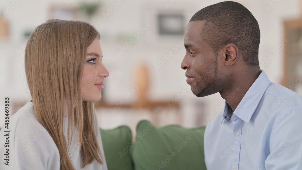 Interracial Couple Looking at Each other Lovingly at Home Interracial Couple Looking at Each other Lovingly at Home