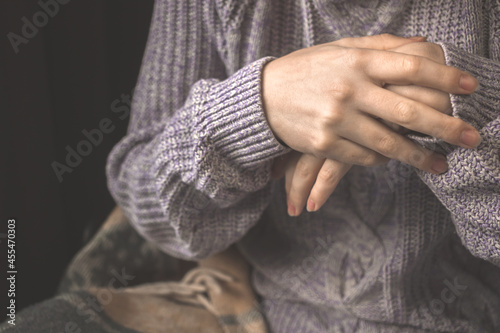 Woman trying to warm the hands, cold hands close-up, female in knitted clothes in winter and autumn season concept photo © FellowNeko