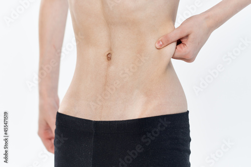 woman pulls in belly strip waist diet health slimming