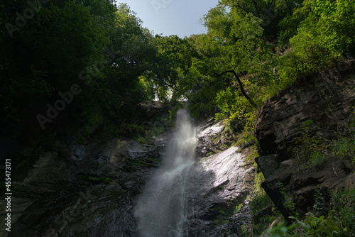 Mountain waterfall in the shade of trees 2