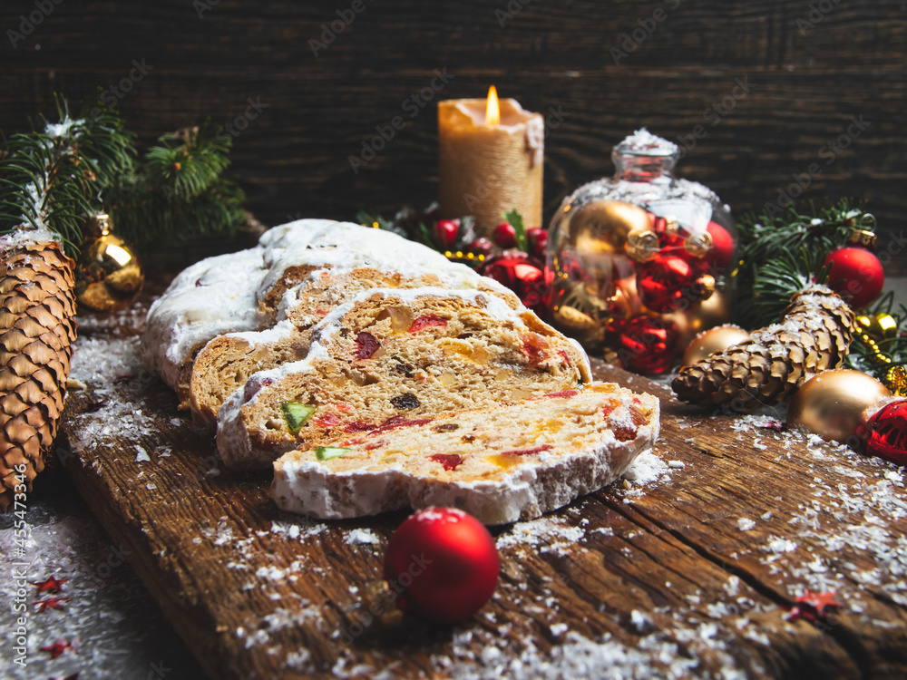 Traditional Christmas stollen, cones, branches of a tree and Christmas decorations, pastry dessert