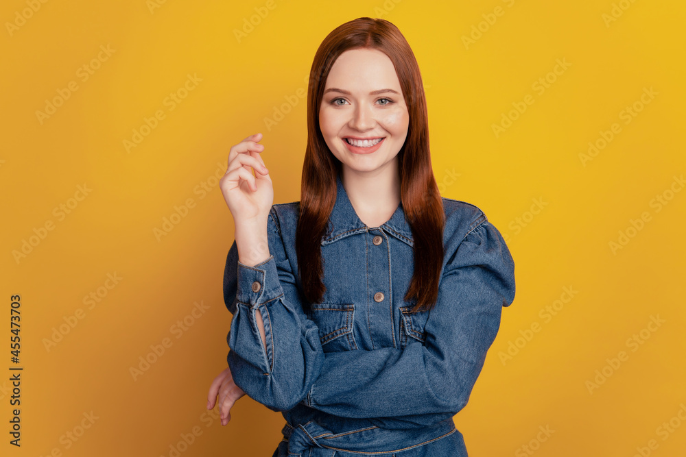 Portrait of charming adorable gorgeous lady hold hand shiny beaming smile on yellow background Portrait of charming adorable gorgeous lady hold hand shiny beaming smile on yellow background