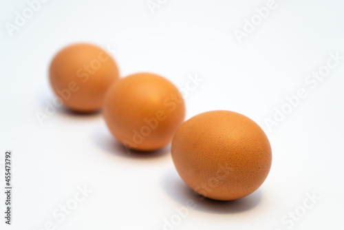 Installation of chicken eggs on a uniform background in different combinations. Diet healthy food