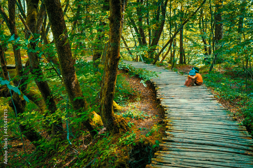 Φωτογραφία True Love: 3-years old girl and 5-years old boy sitting on the wooden boardwalk