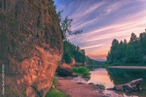 Peaceful landscape with Gauja river and red sandstone Erglu kliffs steep rocks in Gauja National Park in Valmiera area photo