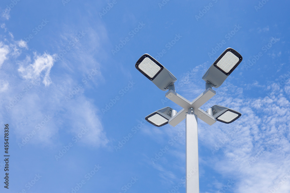 Solar light poles installed outside the building on a bright day sky background. Solar light poles installed outside the building on a bright day sky background.