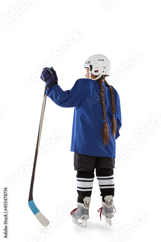 Canvas Print Full-length back view vertical portrait of young female hockey player in blue un