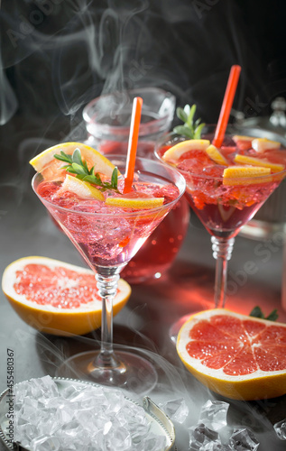 Fruit cocktail, in a glass with natural healthy fruits on a table with kitchen accessories.