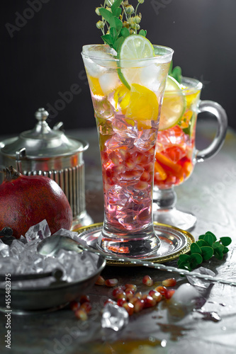 Cocktail in a glass with fruit on an old background.