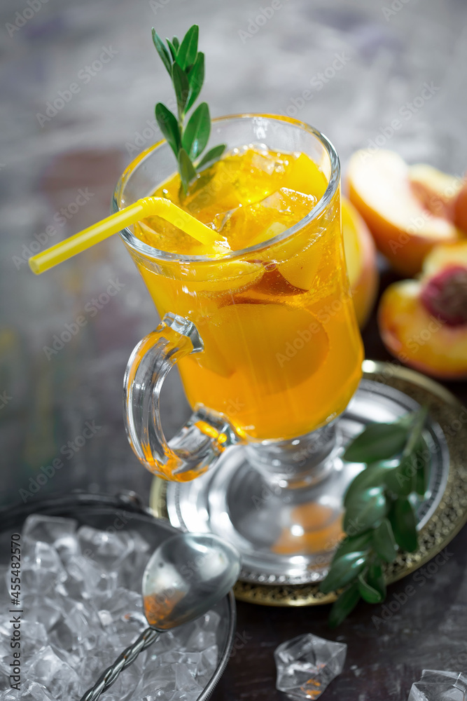 Fototapeta premium Fruit cocktail, in a glass with natural healthy fruits on a table with kitchen accessories.