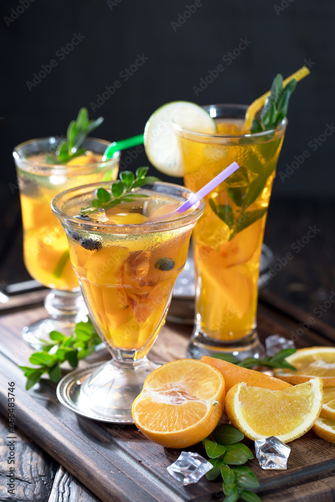 Fototapeta premium Fruit cocktail, in a glass with natural healthy fruits on a table with kitchen accessories.