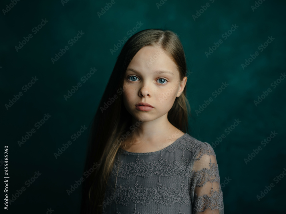 little girl long hair posing green background