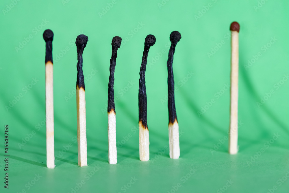 Selective focus. Сlosely located matchsticks burnt, when safe distancing between matchsticks prevents the coronavirus from spreading. Social distancing concept. Selective focus. Сlosely located matchsticks burnt, when safe distancing between matchsticks prevents the coronavirus from spreading. Social distancing concept.