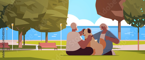 senior couple spending time with dog in urban park relaxation retirement concept