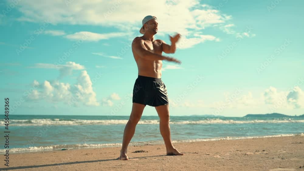 Fit young man practices sun salutation yoga on the beach. Young man enjoying meditation and yoga. fitness, sport, people and lifestyle concept - young man making yoga exercises. Fit young man practices sun salutation yoga on the beach. Young man enjoying meditation and yoga. fitness, sport, people and lifestyle concept - young man making yoga exercises.