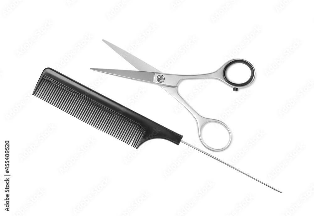 New scissors and comb on white background, top view. Professional tool for haircut New scissors and comb on white background, top view. Professional tool for haircut