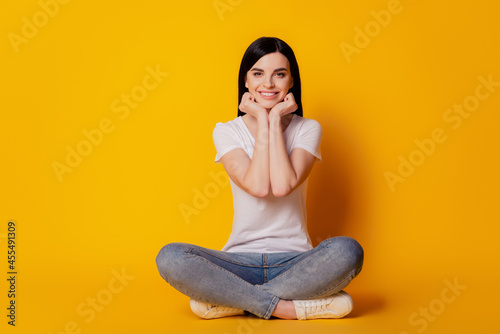 Full body photo of young girl sitting on floor dream rest isolated bright vivid yellow color background